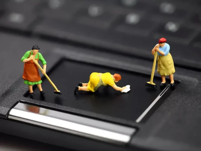 Miniature figurines on top of a laptop.