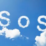 The word sos written in clouds in a blue sky.