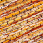 A close up image of a yellow and orange yarn.